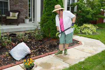 Older lady doing cleaning work in the yard