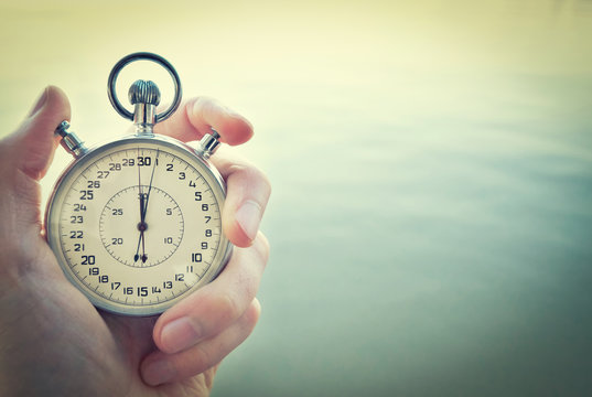 Old chronometer in man hand, vintage  style