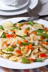 Italian pasta farfalle with vegetables closeup  vertical