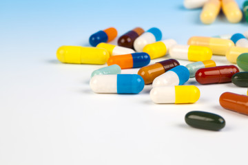 Colorful medical capsules on white background.