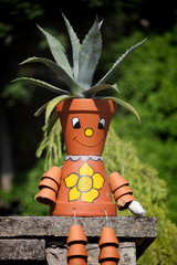 Funny potsherd with plant and funny drawing
