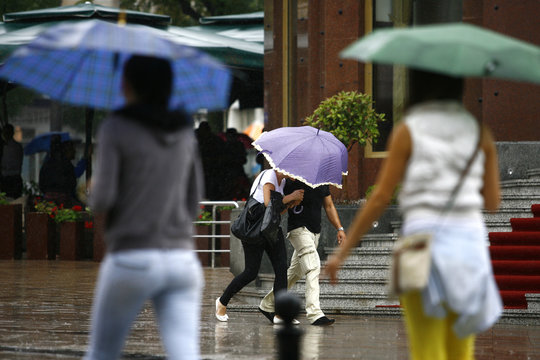 People walking with umbrellas in the rainy city