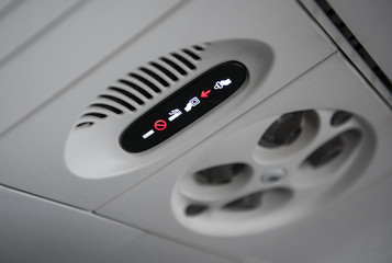 no smoking sign and fasten seat belts sign in plane