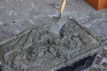 plastic cement mixing trough full with mortar