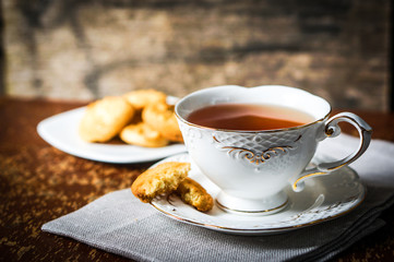 Tea with cookies on wooden background