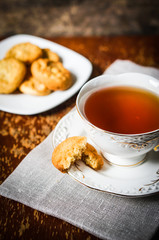 Tea with cookies on wooden background
