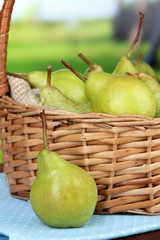 Pears in  wicker basket, on bright background
