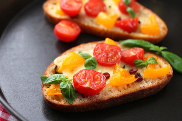Tasty bruschetta with tomatoes in pan, close up