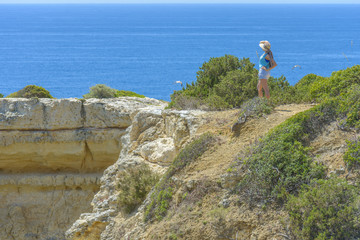 Female tourist looking at the Atlantic Ocean