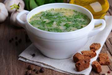 Delicious green soup with sorrel on table close-up