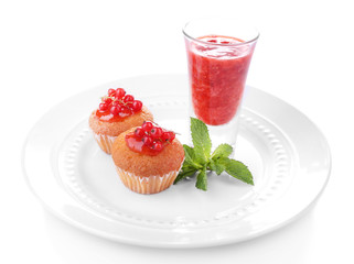 Tasty muffins  red currant sauce on plate isolated on white