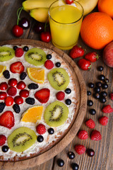 Sweet pizza with fruits on table close-up