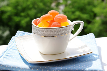 Jelly candies in cup on table close-up