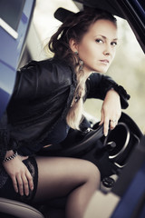 Fototapeta na wymiar Fashion woman sitting in a car