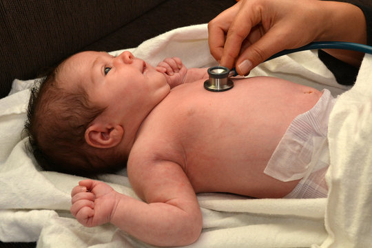 Midwife checks newborn baby