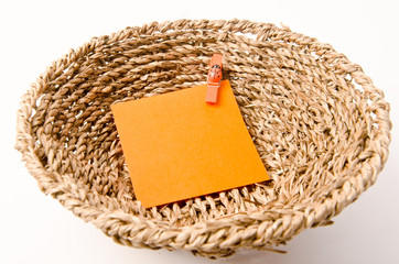 Pinned orange notepad in weave basket