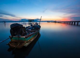 fishing boat in the sea at sunset