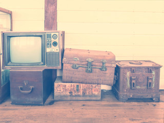 retro tv and boxes on wooden floor, vintage style