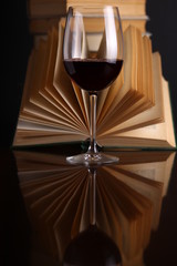 Wine glass and books
