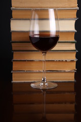 Wine glass and books