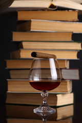 Glass of brandy and books