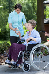 Disabled woman with glass of water