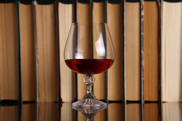 Glass of brandy and books