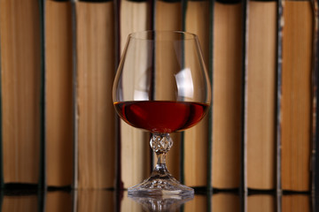 Glass of brandy and books