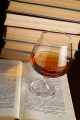 Glass of brandy on books