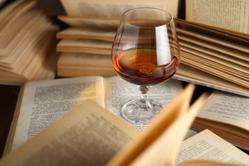Glass of brandy on books
