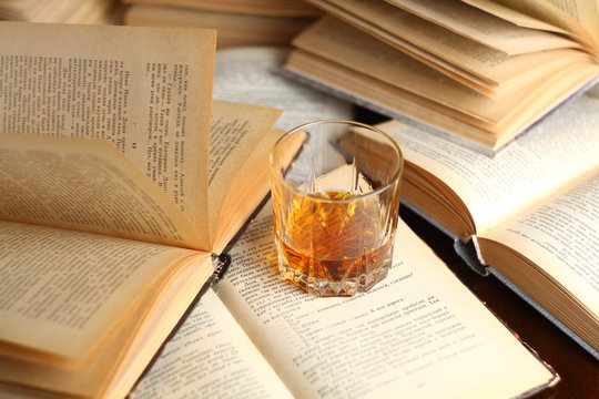 Glass of whiskey on books