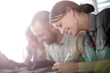 Young people filling admission form for business training
