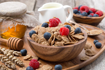 wholegrain flakes with berries, honey and milk for breakfast