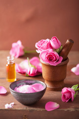 Obraz na płótnie Canvas spa set with rose flowers mortar and salt