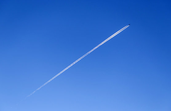 Contrail In A Blue And Orange Sky