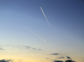 contrail in a blue and orange sky