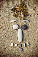 Smiley of stones on sand closeup