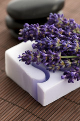 Obraz na płótnie Canvas Bar of natural soap and lavender flowers