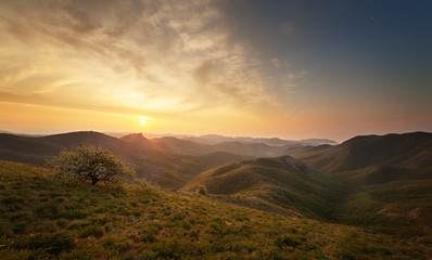 Dawn over the mountains with clouds