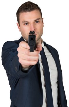Serious businessman pointing a gun