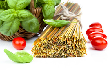 Spaghetti with  tomatoes, and fresh basil leaves. on white backg