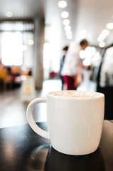 Coffee cup in coffee shop interior