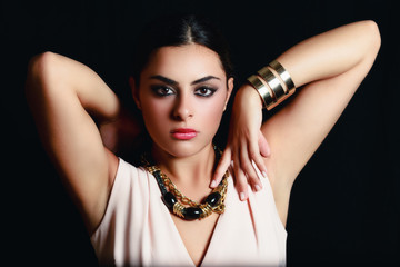 elegant woman indicates necklace