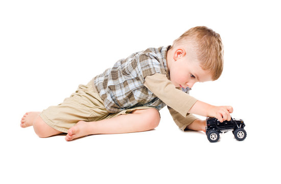 Cute boy playing toy car