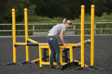 Building a jump for ponies and horses in a riding school