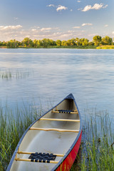 red canoe on lake ready for paddling