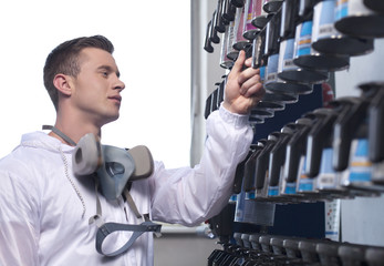 waist up of man selecting car paint.