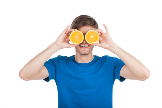 Young Man Holding Two Oranges.