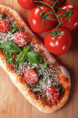 Homemade pizza with basil and cherry tomato