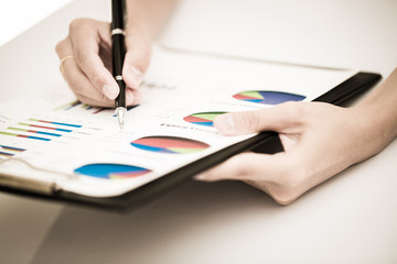 woman hand with pen and business report. Accounting